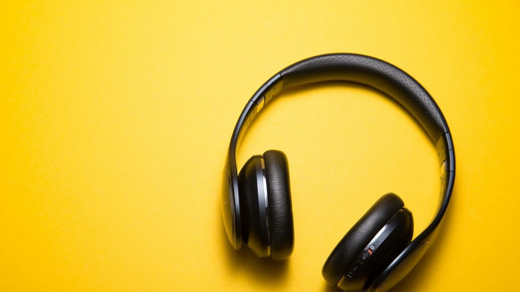flatlay photography of wireless headphones