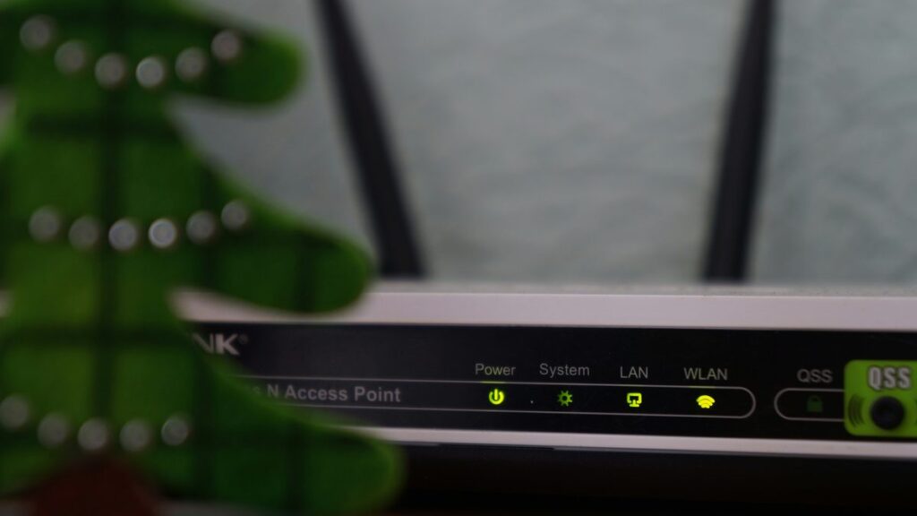 white and black modem router with four lights